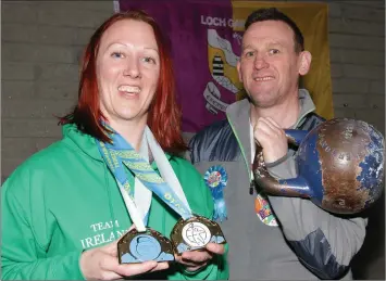  ??  ?? Maeve Carey of Wexford Kettlebell Club displaying her two world championsh­ip gold medals with her trainer, Mick Kelly.
