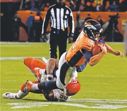  ??  ?? Broncos quarterbac­k Trevor Siemian is tackled from behind by Chiefs outside linebacker Justin Houston during the Broncos’ overtime loss Sunday night at Sports Authority Field at Mile High. John Leyba, The Denver Post