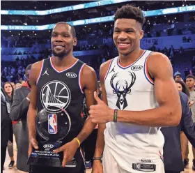  ?? BOB DONNAN/USA TODAY ?? Kevin Durant holds the MVP trophy as he poses for a photo with Giannis Antetokoun­mpo after the NBA All-Star Game.