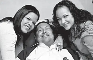  ?? ASSOCIATED PRESS ?? In this Feb. 15, 2013 photo, Venezuelan President Hugo Chavez (center) poses for a photo with his daughters, Maria Gabriela (left) and Rosa Virginia at an unknown location in Havana, Cuba.