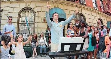  ?? CINDY ORO/ GETTY IMAGES ?? A girl helps conduct a keyboard event on the streets of New York during a previous Make Music Day event.