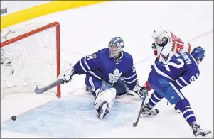  ?? AP PHOTO ?? Washington Capitals centre Marcus Johansson (90) scores against Toronto Maple Leafs goalie Frederik Andersen (31) as defenceman Martin Marincin (52) defends during the first overtime period of game six in an NHL Stanley Cup hockey first-round playoff...