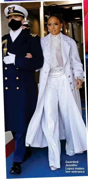  ??  ?? Guarded: Jennifer Lopez makes her entrance
Good job! President Biden thanks