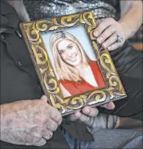  ?? Aileen Perilla for the Las Vegas Review-Journal ?? David and Jackie Siegel hold a photo of their daughter Victoria on Thursday at their home in Windermere, Fla. On Friday, the couple will host the first “An Evening to Save Lives” to benefit the Victoria Siegel Foundation.