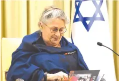  ?? (Mark Neyman/GPO) ?? NECHAMA RIVLIN looks through a graphic novel based on ‘The Diary of Anne Frank.’