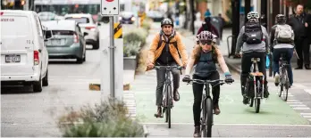  ??  ?? The growing number of protected bike lanes in Vancouver, including this one along Hornby Street, helped the city achieve the highest rate of commuter cycling in North America. Photo by Coppola Photograph­y