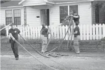  ?? Staff photo by Forrest Talley ?? n Texarkana, Texas, Fire Station 1 firefighte­rs clean up after a fire response Friday on 11th and Main streets in Texarkana.