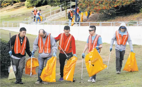  ?? Photos by Paul Chinn / The Chronicle ?? Volunteers spread out across the Lowell High School campus to pick up trash for S.F’s Department of Public Work’s Community Clean Team program.