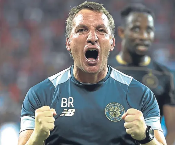  ?? Picture: AP. ?? Brendan Rodgers celebrates leading Celtic to the Champions League group stage despite a 2-0 defeat in Israel.
