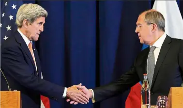  ?? — AP ?? Joint effort: US Secretary of State John Kerry (left) meeting Russian Foreign Minister Sergei Lavrov to discuss the crisis in Syria, in Geneva. The rarely seen cooperatio­n could resonate beyond the Syria conflict.