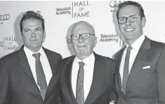  ?? FILE PHOTO BY DAN STEINBERG, AP ?? Rupert Murdoch, center, is flanked by sons Lachlan, left, and James at an event in March 2014. Rupert Murdoch said Thursday he will assume the role of chairman and acting CEO.