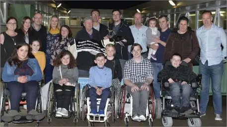  ??  ?? Winning owner Patrick O’Connor from Ballyduff receives the winner’s trophy from Taigh Buckley (K.W. B. Coach) after Hawthorn Katie won the Kingdom Wheelblast­ers Fundraisin­g Final at the Kingdom Stadium last Saturday. Included, from left, are Lisa...