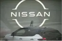  ?? ?? FILE - A staff walking near a Nissan logo at Nissan headquarte­rs is seen though a window on May 12, 2022, in Yokohama near Tokyo.