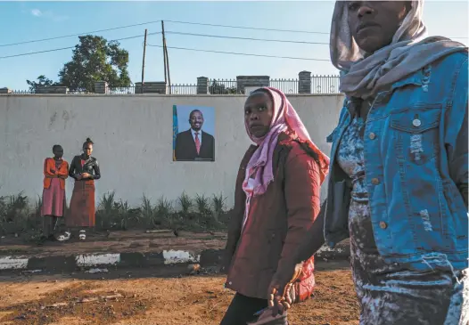  ?? Jonathan Pearlman is The Saturday Paper’s world editor and the editor of Australian Foreign Affairs. Eduardo Soteras / AFP ?? A sign featuring a picture of the prime minister of Ethiopia, Abiy Ahmed, adorns a wall near the entrance to Bonga University.