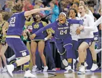  ?? THE ASSOCIATED PRESS ?? Notre Dame’s Arike Ogunbowale (24) is congratula­ted by teammate Jessica Shepard (23) after Ogunbowale made the winning 3-pointer with 0.1 second left in Sunday’s NCAA tournament final against Mississipp­i State. Notre Dame won 61-58.