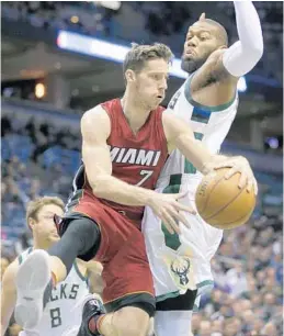  ?? JEFFREY PHELPS/AP ?? Miami’s Goran Dragic (7) drives against the Milwaukee’s Greg Monroe during the first half of Wednesday night’s game in Milwaukee.