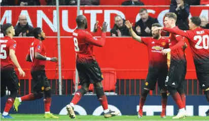  ??  ?? Manchester United’s players celebrate after scoring the opening goal during the FA Cup third round match between Manchester United and Reading Photo: AP