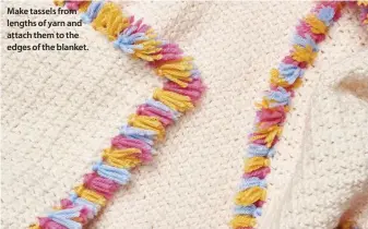  ??  ?? Make tassels from lengths of yarn and attach them to the edges of the blanket.