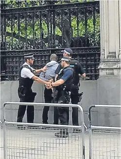  ?? Picture: PA. ?? Police arrest the suspect outside the Palace of Westminste­r. He is being held in custody in central London.