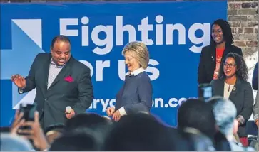  ?? Richard Burkhart
TV One ?? HILLARY RODHAM CLINTON, after a town hall meeting sponsored by the South Carolina Legislativ­e Black Caucus in Orangeburg, learns a dance step from Roland Martin, the host of News One Now.