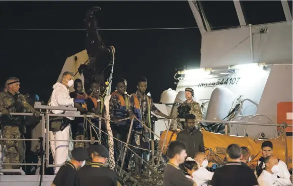  ?? AP ?? Migrants disembark from ‘Protector’ at the port of Pozzallo, Sicily, in the early hours yesterday