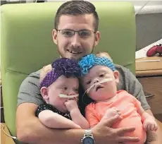  ?? CHILDREN’S HOSPITAL OF PHILADELPH­IA ?? TOP: Heather Delaney holds conjoined twins Abby and Erin. BOTTOM: Riley Delaney holds the girls after their separation surgery.