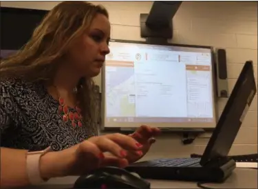  ?? RICHARD PAYERCHIN — THE MORNING JOURNAL ?? Katherine Bray, health education specialist for the Lorain County General Health District, works on an interactiv­e map that was part of a public survey about walking and biking in Lorain.