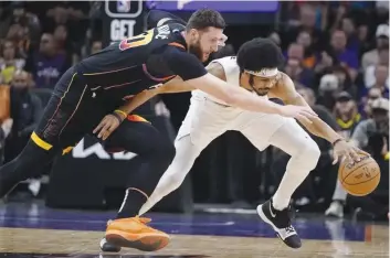  ?? (Darryl Webb / AP photo) ?? Phoenix Suns center Jusuf Nurkic (left) reaches for the ball, while Cleveland Cavaliers center Jarrett Allen gets a hand on it during the first half of an NBA game.