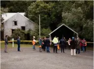  ??  ?? Left Protestors, demolition crew and members of architect John Scott’s family gather outside the Aniwaniwa Visitor Centre on the day demolition was scheduled to begin.