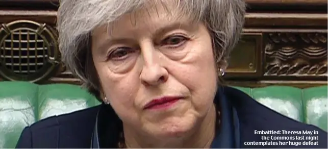  ??  ?? Embattled: Theresa May in the Commons last night contemplat­es her huge defeat