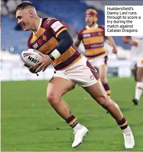  ?? ?? Huddersfie­ld’s Danny Levi runs through to score a try during the match against Catalan Dragons