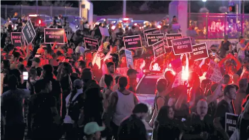  ??  ?? SEEING RED: Protesters are blocked by police as they attempt to walk down a ramp to a highway in St Louis after the not-guilty verdict in the murder trial of police officer Jason Stockley.