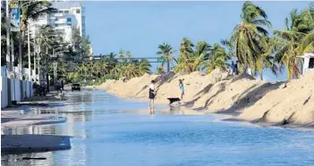  ?? JIM RASSOL/STAFF FILE ?? State Road A1A north of Sunrise Boulevard in Fort Lauderdale is flooded after storms in 2012. Flooding is a growing problem in South Florida, where high annual tides called king tides send water into the streets, even on sunny days.