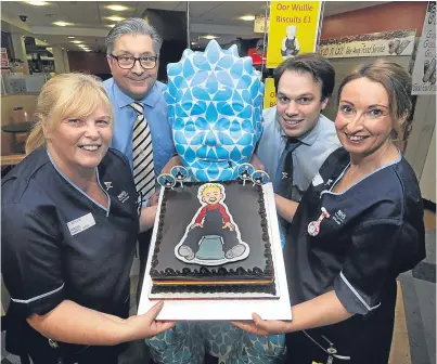 ?? Picture: David Martin. ?? Senior staff nurses Catherine Borland, left, and Suzie Dyer of the children’s ward take charge of the cake donated by Mr Esposito and delivered by Ben Milne of Fisher & Donaldson.