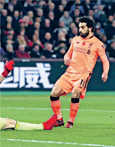  ??  ?? Opening salvo: Mohamed Salah slots past Joe Hart for his and Liverpool’s first goal