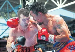  ?? REUTERS ?? Manny Pacquiao fights Jeff Horn, left, at Suncorp Stadium in Brisbane.