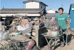  ?? REUTERS ?? A man cleans debris in the aftermath of Typhoon Hagibis in Yanagawama­chi district, Date City, Fukushima prefecture yesterday.