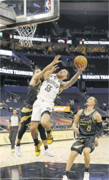  ?? (Photo: AFP) ?? Mike James (foreground) of the Brooklyn Nets shoots the ball during the game against the Toronto Raptors at Amalie Arena in Tampa, Florida, on Tuesday.