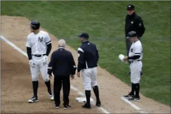  ?? JULIO CORTEZ — THE ASSOCIATED PRESS ?? Yankees’ Aaron Judge, left, suffered a left oblique strain that will keep him sidelined for a lengthy spell.