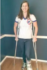  ??  ?? Nell Bochenek with her new protective boot and crutches for the broken foot she suffered celebratin­g the Cubs’ win Saturday that sent them to the World Series. SUPPLIED PHOTO