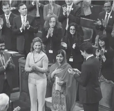 ?? ADRIAN WYLD / THE CANADIAN PRESS ?? Prime Minister Justin Trudeau, Sophie Grégoire Trudeau, politician­s and guests applaud Malala Yousafzai following her address to Parliament on Wednesday in Ottawa.