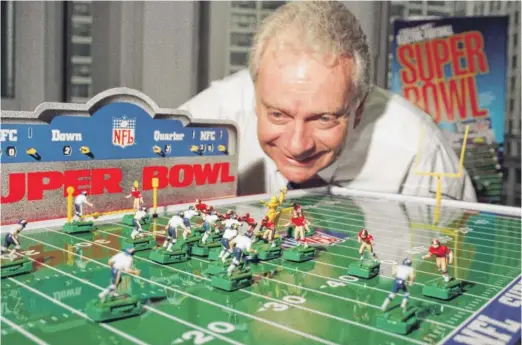  ?? SUN-TIMES FILE ?? Michael Landsman of Miggle Toys, a maker of electric football, demonstrat­es a game in 1996. Users could control the players — or at least that was the idea.
