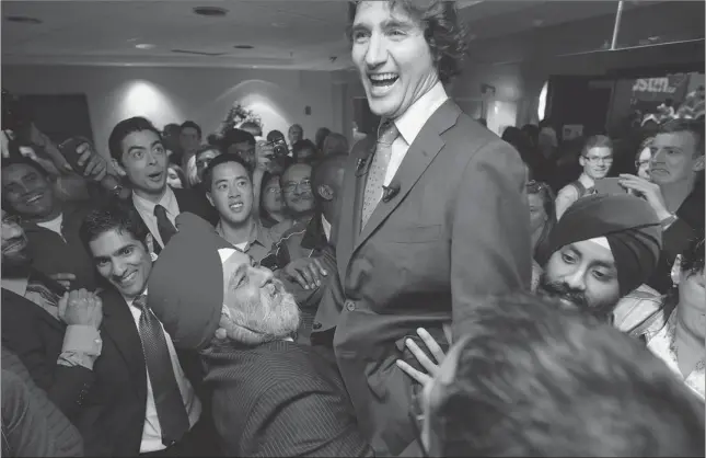  ?? JONATHAN HAYWARD/THE Canadian Press ?? A supporter picks up Justin Trudeau following an event in Richmond, B.C. on Wednesday. Trudeau announced this week that he will run for the leadership of the federal Liberal party.