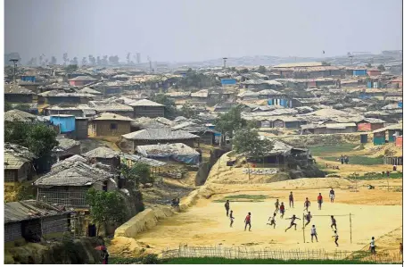  ?? — Reuters ?? Passing the time: Rohingya refugees playing football at a clearing in Kutupalong refugee camp in Cox’s Bazaar, Bangladesh.
