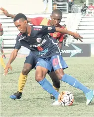  ?? FILE PHOTOS ?? St Andrew Technical’s Steven McQueen and Jamaica College’s Tyreek McGhee (foreground) fight for possession of the ball during a ISSA-Flow Manning Cup contest earlier this season.