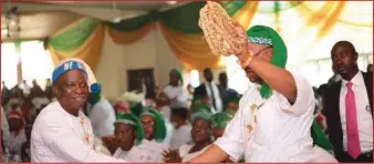  ??  ?? Gov. Udom Emmanuel receives a traditiona­l symbol of strenght and industry