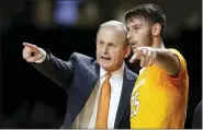  ?? MARK HUMPHREY — THE ASSOCIATED PRESS FILE ?? In this Saturday, Jan. 18, 2020, file photo, Tennessee coach Rick Barnes talks with guard Santiago Vescovi, of Uruguay, during the second half of the team’s NCAA college basketball game against Vanderbilt in Nashville, Tenn. With competitio­n canceled across all NCAA divisions due to the coronaviru­s, many foreign athletes face a dilemma, return home or stay. Tennessee’s men’s basketball team has players from France, Serbia, Uruguay and Finland, which meant Mary-Carter Eggert, the director of basketball operations, became a travel agent, looking for the best flights.