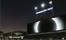  ?? Carolyn Kaster/Associated Press ?? The large video screen over Progressiv­e Field displays the total solar eclipse Monday in Cleveland before the Guardians’ home opener baseball game against the Chicago White Sox.