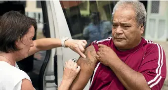  ??  ?? Sinopati Simisi, 57, receives his measles vaccinatio­n at a mobile immunisati­on van outside the Lotonuumon­i Hall at Lalomanu beach.