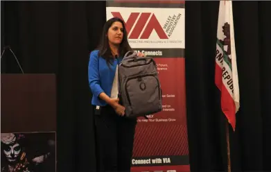  ?? Tammy Murga/The Signal ?? Jenny Ketchepaw, vice president and training manager at Citizens Business Bank, demonstrat­es a backpack that turns into a bulletproo­f vest during the Valley Industry Associatio­n’s active shooter training luncheon on Tuesday.